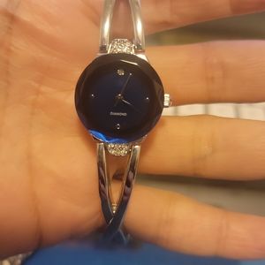 Diamond Co Saphire Colored Face W/ White Stone Accents Analog Watch